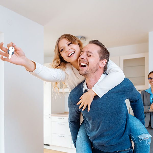For Buyers happy couple with keys to new home